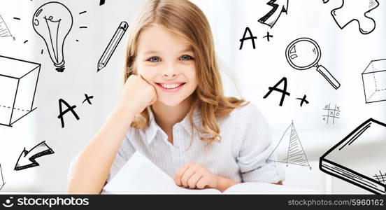 education and school concept - little student girl studying at school. little student girl studying at school