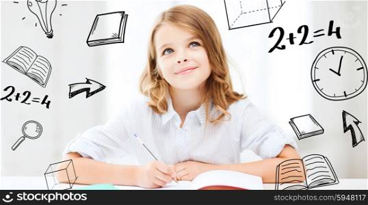 education and school concept - little student girl studying at school. student girl studying at school