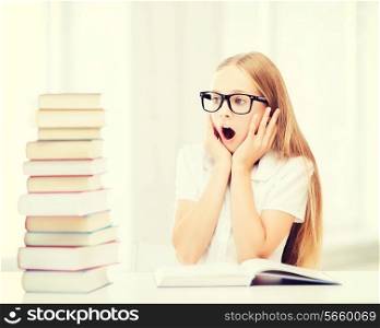 education and school concept - little student girl with many books at school
