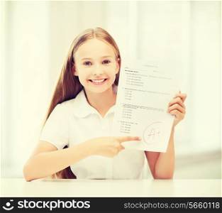 education and school concept - little student girl with test and A grade at school