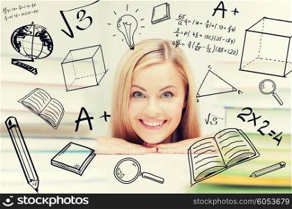 education and school concept - smiling student with stack of books and doodles. student with stack of books and doodles