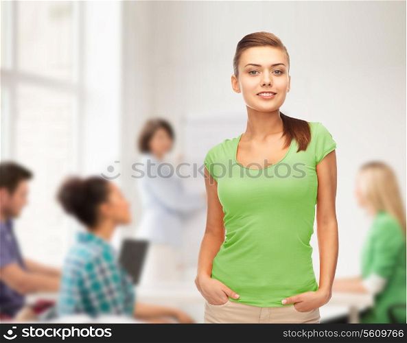 education and school concept - smiling young woman in blank green t-shirt