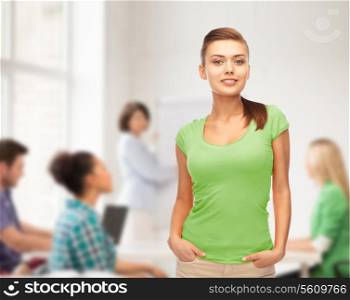 education and school concept - smiling young woman in blank green t-shirt