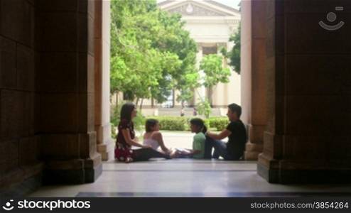 Education and students in university, group of young men and women talking and relaxing in college, University of Havana, Cuba