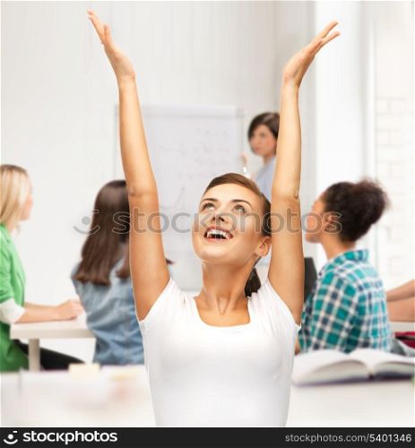 education and success concept - happy student girl with hands up