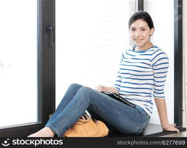 education and technology concept - happy and smiling teenage girl with laptop