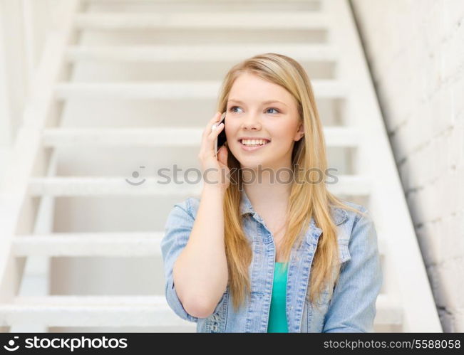 education and technology concept - smiling female student with smartphone sitting on staircase