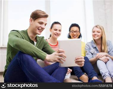 education and technology concept - smiling students making picture with tablet pc computer at home
