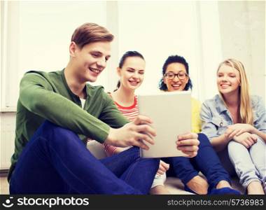 education and technology concept - smiling students making picture with tablet pc computer at home