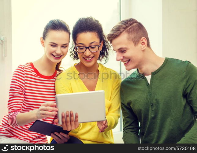 education and technology concept - smiling students with tablet pc computer at school