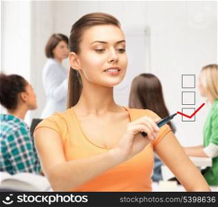 education and technology concept - student drawing checkmark on virtual screen