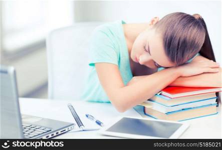 education and technology concept - tired student sleeping on stack of books. tired student sleeping on stock of books