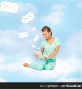 education and technology concept - young woman sitting on the cloud with tablet pc