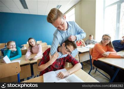 education, bullying, violence, aggression and people concept - student boy suffering of classmate mockery