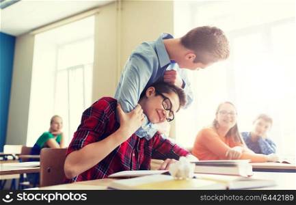 education, bullying, violence, aggression and people concept - student boy suffering of classmate mockery. student boy suffering of classmate mockery