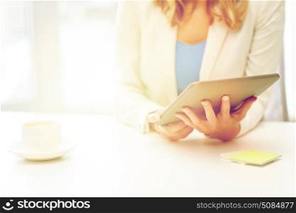 education, business and technology concept - close up of businesswoman or student with tablet pc computer and coffee cup at office table. close up of businesswoman with tablet pc . close up of businesswoman with tablet pc