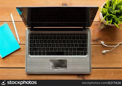 education, business and technology concept - close up of laptop computer on wooden table