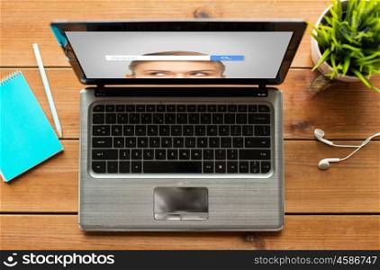 education, business and technology concept - close up of laptop computer with internet browser search bar on screen on wooden table