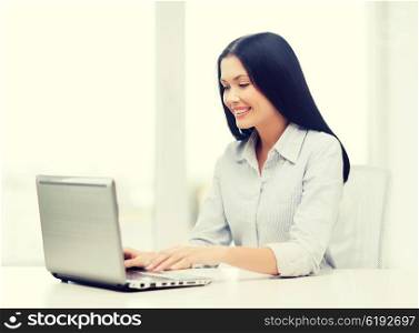 education, business and technology concept - smiling businesswoman or student with laptop computer