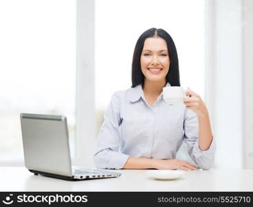 education, business and technology concept - smiling businesswoman or student with laptop computer and coffee