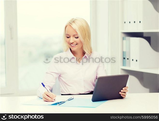 education, business and technology concept - smiling businesswoman with tablet pc computer filling documents or taking notes in office