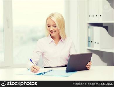 education, business and technology concept - smiling businesswoman with tablet pc computer filling documents or taking notes in office