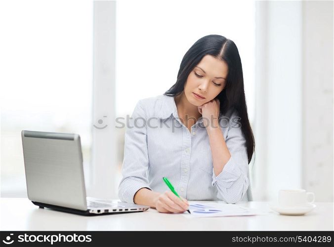 education, business and technology concept - tired businesswoman or student with laptop computer, charts and coffee