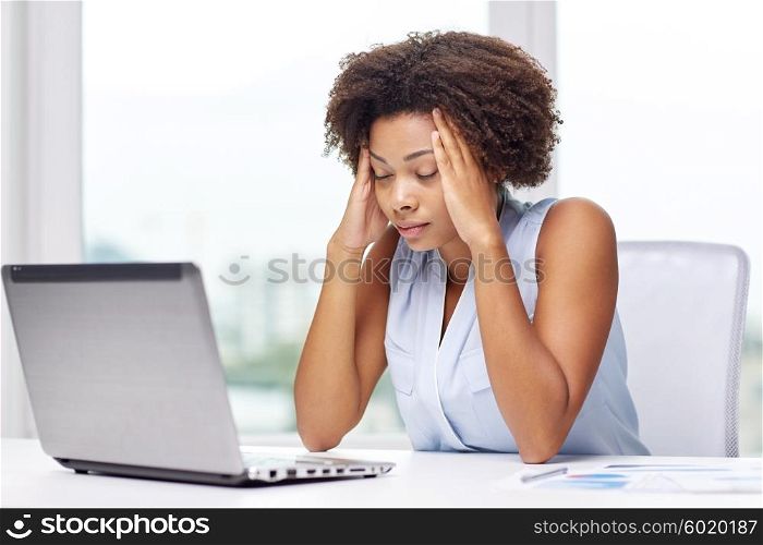 education, business, fail and technology concept - african american businesswoman or student with laptop computer and papers at office