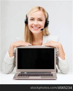 education, business, technology, advertisement and people concept - smiling young woman or helpline operator in headset with blank screen on laptop computer