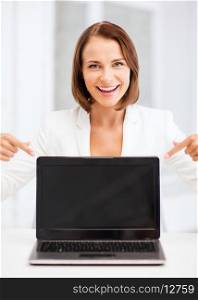 education, business, technology and internet concept - smiling woman with laptop pc