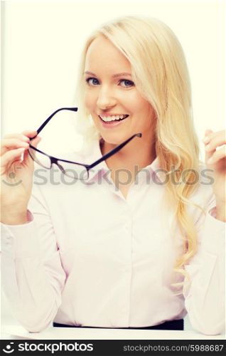 education, business, vision and people concept - smiling businesswoman, student or secretary wearing eyeglasses in office