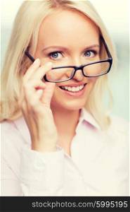 education, business, vision and people concept - smiling businesswoman, student or secretary wearing eyeglasses in office