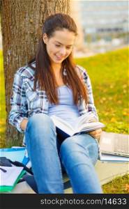 education, campus and people concept - smiling teenager reading book