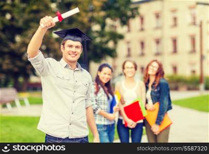 education, campus and teenage concept - smiling teenage boy in corner-cap with diploma and classmates on the back