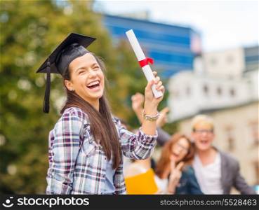 education, campus and teenage concept - smiling teenage girl in corner-cap with diploma and classmates on the back