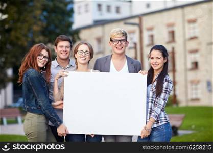 education, campus, friendship and people concept - group of happy teenage students holding big white blank billboard