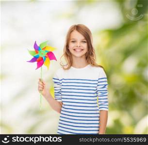 education, childhood and ecology concept - smiling child with colorful windmill toy