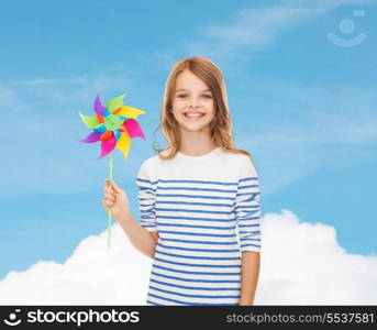 education, childhood and ecology concept - smiling child with colorful windmill toy