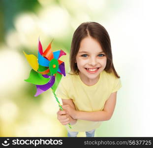 education, childhood and ecology concept - smiling child with colorful windmill toy