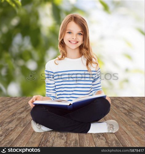 education, childhood, people and school concept - little student girl studying and reading book over greed background