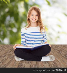 education, childhood, people and school concept - little student girl studying and reading book over greed background