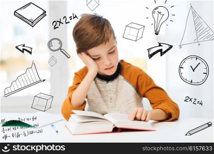 education, childhood, people, homework and school concept - bored student boy reading book or textbook at home over mathematical doodles