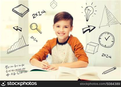 education, childhood, people, homework and school concept - smiling student boy with book writing to notebook at home over mathematical doodles. smiling student boy writing to notebook at home. smiling student boy writing to notebook at home