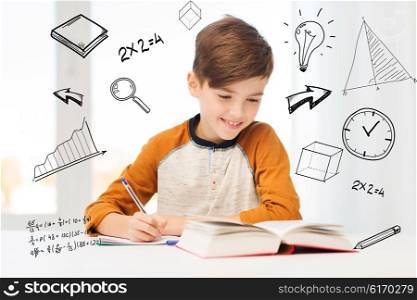 education, childhood, people, homework and school concept - smiling student boy with book writing to notebook at home over mathematical doodles