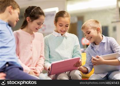 education, children and people concept - group of happy kids with tablet pc computer learning at school