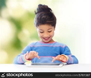 education, children, technology and people concept - happy little girl with tablet pc computer over green background