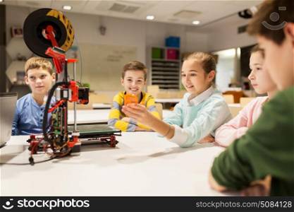education, children, technology, science and people concept - group of happy kids with 3d printer and plastic detail prototype at robotics school lesson. happy children with 3d printer at robotics school. happy children with 3d printer at robotics school