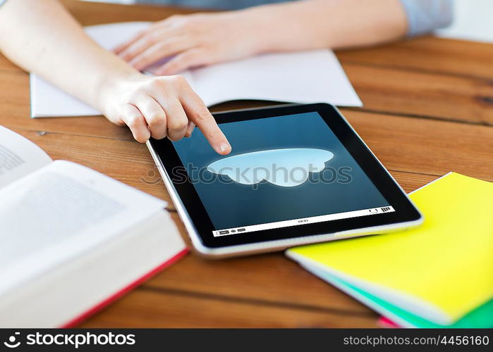 education, computing, technology and internet concept - close up of student woman with cloud icon on tablet pc computer and notebook at home