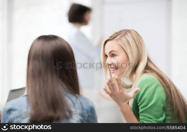 education concept - attractive student girl gossiping in lecture at school