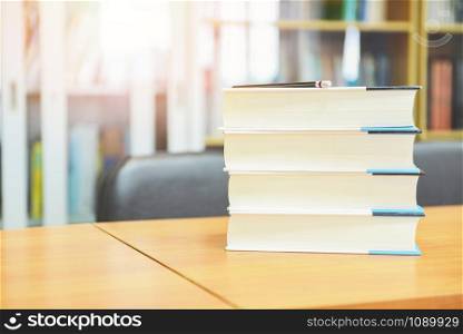 Education concept back to school and study / book in library with book stacked on the table with pencil